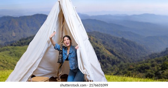 Asian Woman Greeting Friend While On A Solo Trekking Camp On The Top Of The Mountain With Small Tent For Weekend Activities And Outdoor Pursuit Concept