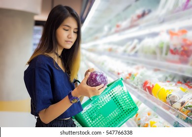 Asian Woman Grocery Shopping At The Supermarket.