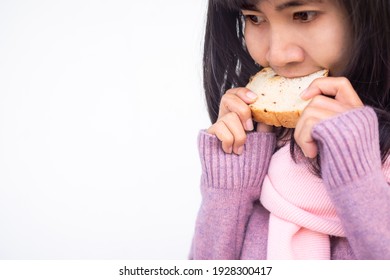 Asian Woman With Guernsey  Eating Raisin Bread Starving And Delicious In Morning Of Winter. Breakfast Or Snack Food Concept.