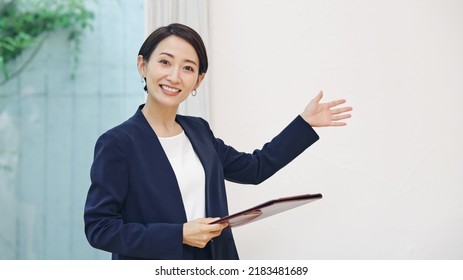 Asian woman guiding the room. Online private view. - Shutterstock ID 2183481689