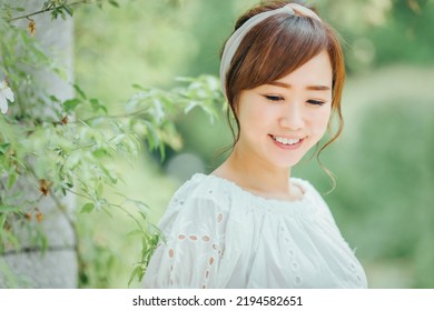 Asian Woman With Hair Band In Green