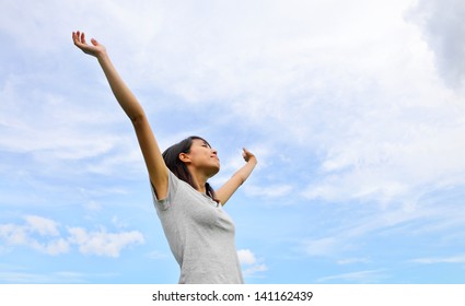 Asian Woman Hand Up With Blue Sky Background