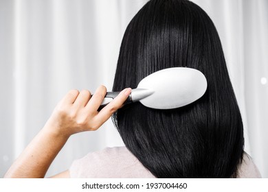 Asian Woman Hand Holding Comb Brushing Her Beautiful Long Black And Shiny Hair 