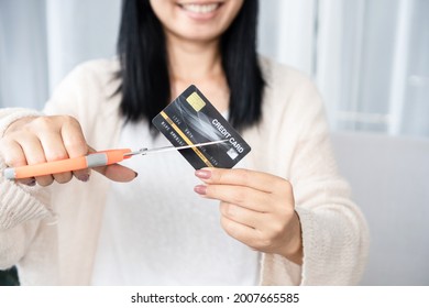 Asian Woman Hand Holding Scissors Cutting Credit Card Financial, Debt Freedom Concept 