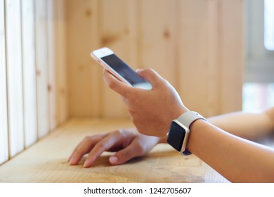 Asian Woman Hand Holding And Using Smart Phone Show Back Side Isolated