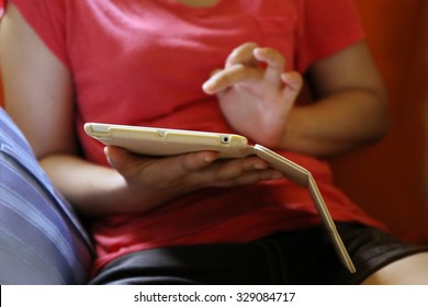  asian woman hand use tablet on sofa,using mobile slim tablet, Internet of things lifestyle with wireless communication and internet with smart phone.
