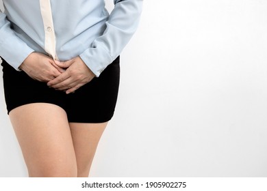 Asian woman with hands holding pressing crotch lower abdomen,female suffering from stomach ache,frequent painful urination,urinary tract Infection,urinary incontinence,cystitis,gynecological problems
