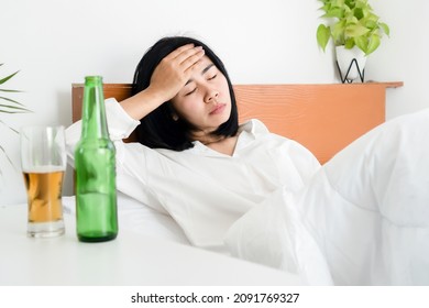 Asian Woman Hangover And Having A Headache After Drinking Beer Wakeup In Morning Lying Down In Bed 