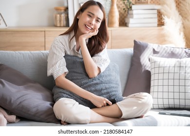 Asian Woman Happily Watch Tv Comedy Series On Sofa Living Room At Home