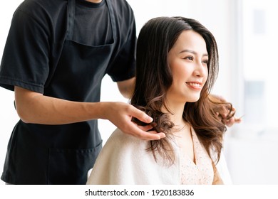 Asian woman with happy expression doing hairdressing at salong - Powered by Shutterstock