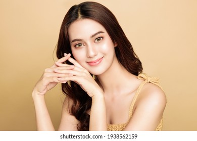 Asian Woman Are Happy With Perfect Clean Healthy Skin And Beautiful Long Brown Hair. Cute Female Model Clean Fresh Skin . Expressive Facial Expressions. Cosmetology Concept.