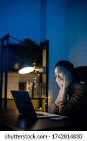 Asian Woman Happy Smiling Working On A Laptop At The Night At Home. WFH. Work From Home Avoid COVID 19 Concept.