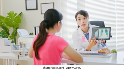 Asian Woman Has Breast Cancer Diagnosis In Hospital - Female Doctor Showing Mammography Test Results And Xray To Patient On Digital Tablet