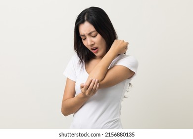 Asian woman has problem with structural posture She has elbow hurts. She massaged for relief. reduce muscle tension. Standing on isolated white background - Shutterstock ID 2156880135