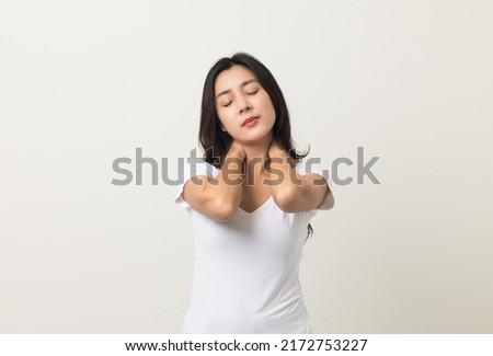 Asian woman has problem with structural posture She had neck and shoulder pain. She massaged her neck and shoulders for relief. reduce muscle tension. Standing on isolated white background
