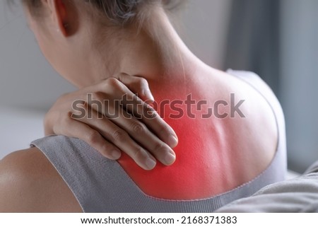 Asian woman has shoulder pain. Female holding painful shoulder with another hand. People with body-muscles problem, Healthcare And Medicine.