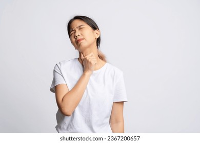 Asian woman has sore throat isolated on white background - Shutterstock ID 2367200657