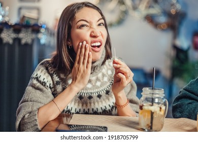Asian woman has a toothache after a big meal and she pulls out the remains of food from the cavity in her teeth with a toothpick. The concept of dental health and cleaning - Shutterstock ID 1918705799