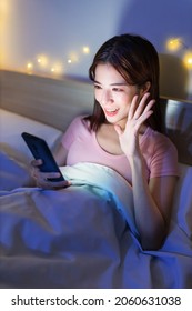 Asian Woman Has Video Chat By Smartphone On Bed At Night