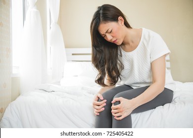 Asian Woman Have A Knee Ache On Morning In Bedroom