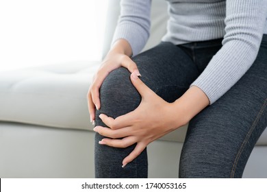 asian woman have a muscle pain or joint knee arthriti bone injury from exercise workout accident at home - Powered by Shutterstock