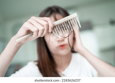 Asian Woman Have Problem With Long Hair Loss Attach To Comb Brush.