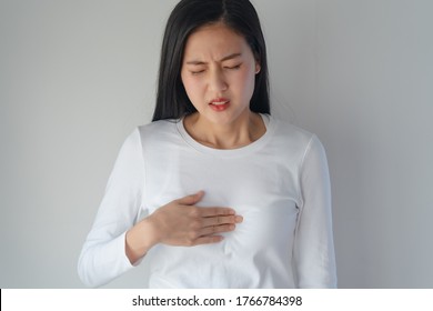 Asian Woman Having Reflux Acids And Pain In The Chest.