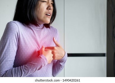 Asian Woman Having Or Symptomatic Reflux Acids,Gastroesophageal Reflux Disease,Because The Esophageal Sphincter That Separates The Esophagus And Stomach Dysfunction