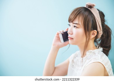 Asian woman having trouble while talking on a smartphone