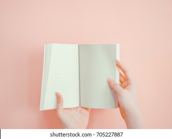 Asian Woman Hold And Open Blank Page Of Book By Both Hand With Pink Pastel Background