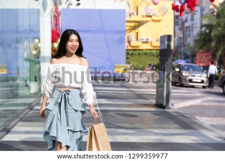 asian woman holding a bag