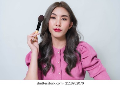 Asian Woman Holding A Blush Brush. Concept Photo Of A Beautiful Asian Makeup Artist.