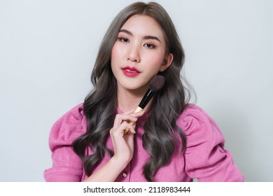 Asian Woman Holding A Blush Brush. Concept Photo Of A Beautiful Asian Makeup Artist.