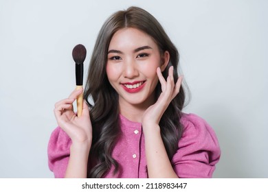 Asian Woman Holding A Blush Brush. Concept Photo Of A Beautiful Asian Makeup Artist.