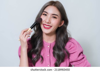 Asian Woman Holding A Blush Brush. Concept Photo Of A Beautiful Asian Makeup Artist.