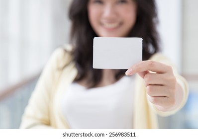 Asian Woman Holding A Card In Her Hand