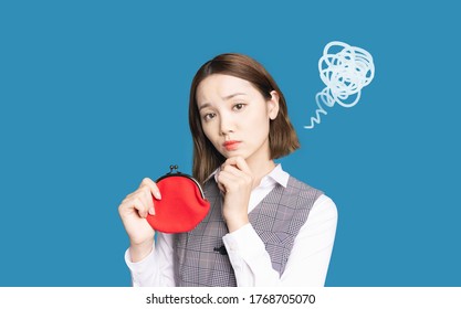 Asian woman holding a coin purse. Lack of money. - Shutterstock ID 1768705070