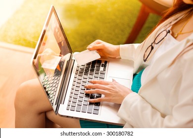 Asian Woman Holding Credit Card And Typing Keyboard Laptop For Online Shopping.