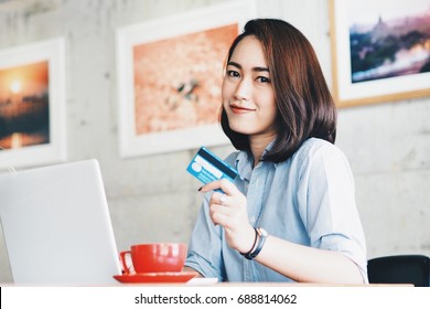 Asian Woman Holding Credit Card In Hand.