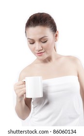 asian woman holding a cup, and looking at her cup