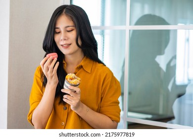 Asian Woman Holding Deliciously Fragrant Bread  Homemade Cooking By Herself And Snacks Just Baked From The Oven In The Kitchen At Home.