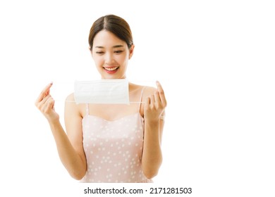 Asian Woman Holding Facemask And Smiling After Getting Vaccine Which Is Using For Protect Corona Virus Spread Out From The Air. Asia Female Showing Surgical Mask Preparing Before Going Public Area.