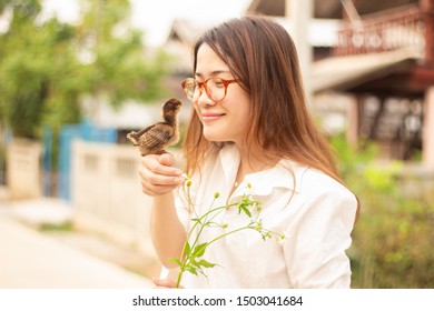 Asian Woman Holding Furry Chicken Baby