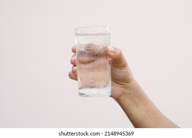 Asian Woman Holding A Glass Of Cold Water For Drinking