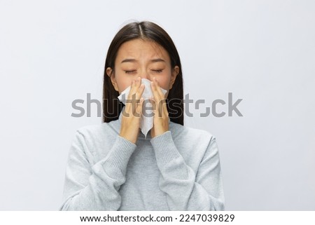 Asian woman holding hand with handkerchief and coughing up flu and cold, stuffy nose viral disease covid 19 white background