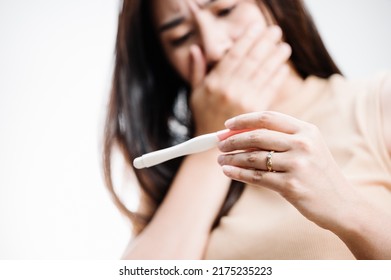 Asian woman holding pregnancy test feeling disappointed by negative result female health problems and infertility. or unwilling pregnancy, abortion. - Shutterstock ID 2175235223
