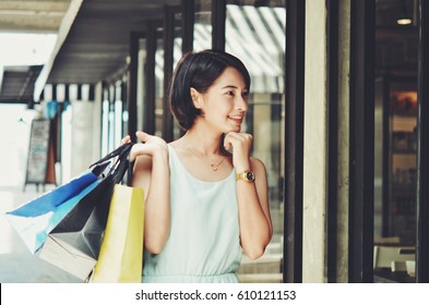 Asian Woman Holding Shopping Bag In Her Hand, Smiling Asian In Casual Dress Shopping At Outdoor.