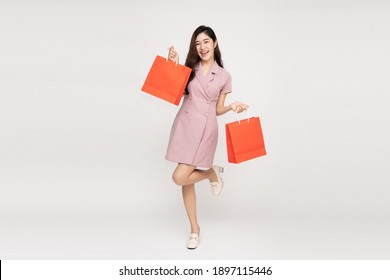 Asian Woman Holding Shopping Bags In Full Body Isolated On White Background, Shopper Or Shopaholic Concept