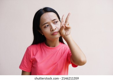 Asian Woman Holding Up Two Fingers Means Fight