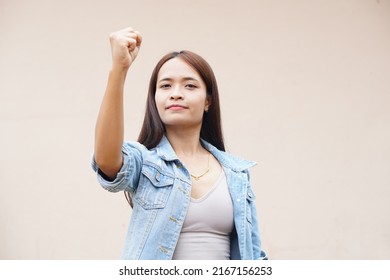 Asian Woman Holding Up Two Fingers